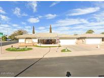 Charming single-story home with an inviting covered porch and well-maintained front yard landscaping at 8242 E Lomita Ave, Mesa, AZ 85209