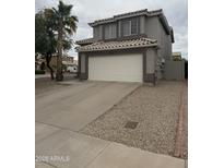 Two-story home featuring an attached two-car garage, desert landscaping, and a tile roof at 1655 W Stanford Ave, Gilbert, AZ 85233