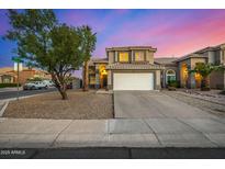 Charming two-story home showcasing a wide driveway, desert landscaping, and neutral tones at 1655 W Stanford Ave, Gilbert, AZ 85233