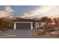 Charming single-story home featuring desert landscaping, a two-car garage, and a welcoming entrance at 17165 N Lariat Rd, Maricopa, AZ 85138