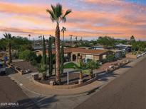 Stunning home with manicured desert landscaping and a circular driveway at sunset at 19615 N 18Th Dr, Phoenix, AZ 85027