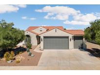 Beautiful single-story home featuring a terracotta roof, desert landscaping, and a spacious three-car garage at 21532 N 262Nd Ln, Buckeye, AZ 85396