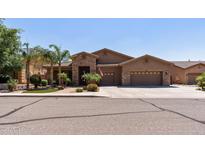 Charming home featuring a three-car garage, desert landscaping, and a stone-accented entry at 27421 N 22Nd Ln, Phoenix, AZ 85085