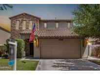 Charming two-story home with a stone facade, tiled roof, well-maintained lawn, and a two-car garage at 4258 E Lexington Ave, Gilbert, AZ 85234