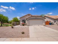 Charming single-story home featuring a two-car garage and low-maintenance desert landscaping in front yard at 4518 W Carson Rd, Laveen, AZ 85339