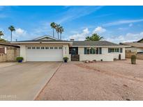 Charming single-story home featuring a well-manicured front yard, desert landscaping, and an attached two-car garage at 8713 E Citrus Way, Scottsdale, AZ 85250