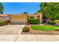 Charming single-story home featuring a well-manicured lawn, desert landscaping, and a neutral-toned exterior at 941 N Benson Ln, Chandler, AZ 85224
