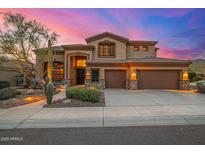 Stunning two-story home with a three-car garage, desert landscaping, and a beautiful sunset backdrop at 11124 N 138Th Way, Scottsdale, AZ 85259