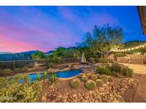 A backyard pool and spa with a built in grill on a desert landscaped lot with mountain views at 11124 N 138Th Way, Scottsdale, AZ 85259