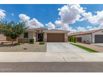 Charming single-story home featuring a well-manicured yard, neutral colors and a two car garage at 12289 E Ballentine Rd, Gold Canyon, AZ 85118