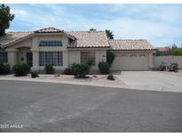 Charming single-story home features a two-car garage, desert landscaping, and a tile roof at 1333 N Higley Rd # 7, Mesa, AZ 85205