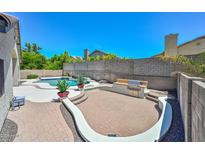 A beautiful backyard featuring a pool, built-in BBQ, and a red brick patio perfect for outdoor entertaining at 1623 E Runion Dr, Phoenix, AZ 85024