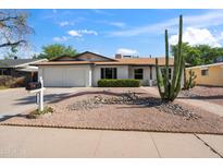 Charming single-story home featuring a two-car garage and a low-maintenance desert-style yard at 1713 W Royal Palm Rd, Phoenix, AZ 85021
