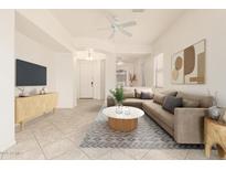 Bright living room with neutral decor, comfortable seating, and modern ceiling fan at 1887 W Periwinkle Way, Chandler, AZ 85248