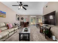 Inviting living room features plush seating, ceiling fan, modern coffee table, and seamless access to the outdoor balcony at 1920 E Bell Rd # 1189, Phoenix, AZ 85022