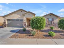 Charming single-story home featuring a two-car garage and desert landscaping at 40657 W Somers Dr, Maricopa, AZ 85138