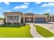 Charming single-story home featuring a low maintenance lawn and a two-car garage with beautiful stonework at 4236 S John Way, Chandler, AZ 85249