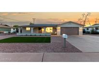 Charming single-story home featuring a quaint porch and a well-maintained front yard at 434 N 56Th St, Mesa, AZ 85205