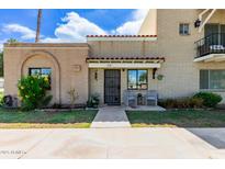 Charming brick home with a cozy front porch and well-maintained landscaping at 541 N Lesueur St, Mesa, AZ 85203