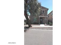 Charming two-story home with neutral-toned exterior and well-maintained landscaping at 7325 W Wilshire Dr, Phoenix, AZ 85035
