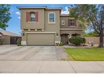 Two-story home featuring a spacious two-car garage, red shutters, and well-maintained landscaping at 1145 E Harold Dr, San Tan Valley, AZ 85140