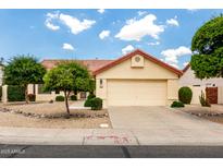 Charming home featuring a two-car garage and a well-maintained front yard with desert landscaping at 11524 W Rosewood Dr, Avondale, AZ 85392