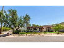 Charming single-story home with a red tile roof and inviting front yard landscaping at 12835 N 16Th Dr, Phoenix, AZ 85029