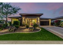 Charming single-story home with a modern design, desert landscaping and a cozy front porch at 13252 W Steed Ridge Rd, Peoria, AZ 85383