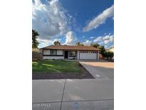 Charming single-story home featuring a well-manicured lawn and a two-car garage at 1616 W Temple St, Chandler, AZ 85224