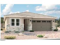 Charming single-story home featuring stone accents, neutral color palette, and a two-car garage at 16974 W Winston Dr, Goodyear, AZ 85338