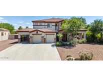 Beautiful two-story home featuring a stone-accented facade, a red tile roof, and a spacious three-car garage at 18329 W Montebello Ave, Litchfield Park, AZ 85340