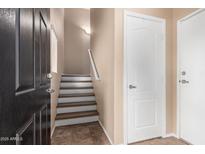 The home's welcoming entryway features a staircase and a convenient coat closet at 2401 E Rio Salado Pkwy # 1192, Tempe, AZ 85288