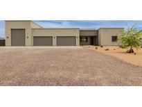 Contemporary home featuring a three car garage, desert landscaping, and neutral color palette at 2516 W Joy Ranch Rd, Phoenix, AZ 85086