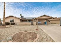 Single-story home featuring desert landscaping, a covered porch, and a convenient carport at 3410 W Pershing Ave, Phoenix, AZ 85029