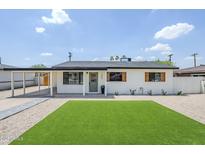 Charming single-story home with fresh exterior paint, a covered carport, and manicured landscaping at 3609 E Palm Ln, Phoenix, AZ 85008