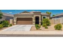 Charming single-story home with a well-manicured front yard and a two-car garage at 36412 W Pampoloma Ave, Maricopa, AZ 85138