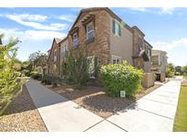 Charming townhouse with stone facade, neat landscaping, and inviting curb appeal at 4716 E Red Oak Ln # 102, Gilbert, AZ 85297