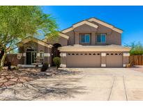 Stunning two-story home featuring a spacious three-car garage and beautifully landscaped front yard at 4801 E Quien Sabe Way, Cave Creek, AZ 85331