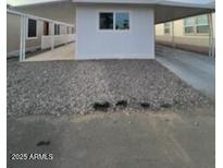 This property features a covered parking area, gravel landscaping, and a clean, modern exterior at 500 N 67 Ave # 149, Phoenix, AZ 85043