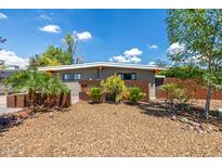 Charming single-story home featuring desert landscaping, unique rusted steel accents, and a neutral color scheme at 5739 N 11Th St, Phoenix, AZ 85014
