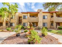 Attractive building exterior with mature landscaping and a decorative water feature at 7008 E Gold Dust Ave # 236, Scottsdale, AZ 85253