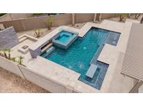 Aerial view of the custom backyard featuring a pool, spa, fountain, and firepit at 10261 W Foothill Dr, Peoria, AZ 85383