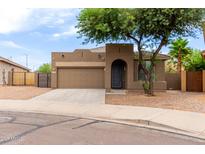 Charming single-story home featuring a two-car garage and desert landscaping at 10261 W Foothill Dr, Peoria, AZ 85383