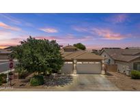 Charming single-story home with a three-car garage and well-maintained landscaping at 14676 W Banff Ln, Surprise, AZ 85379
