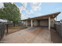 Charming single-story home featuring a covered parking area and well-maintained front yard at 1614 S 6Th Ave, Phoenix, AZ 85003