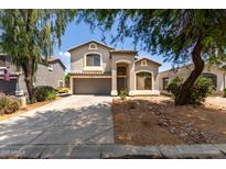 Charming two-story home with a well-manicured front yard and a two car garage at 1632 E Leslie Ave, San Tan Valley, AZ 85140