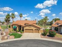 Stunning home with a tile roof, three-car garage, and lush landscaping at 18851 N 69Th Ave, Glendale, AZ 85308