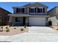 Beautiful two-story home featuring a well-manicured front yard and two-car garage at 31866 N Bandit Rd, San Tan Valley, AZ 85143