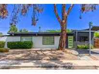 Contemporary home featuring a white brick facade, green door, and professionally landscaped front yard at 3710 E Altadena Ave, Phoenix, AZ 85028