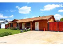 Charming single-story home features a well-maintained front yard with lush green grass and a spacious driveway at 3723 W Columbine Dr, Phoenix, AZ 85029